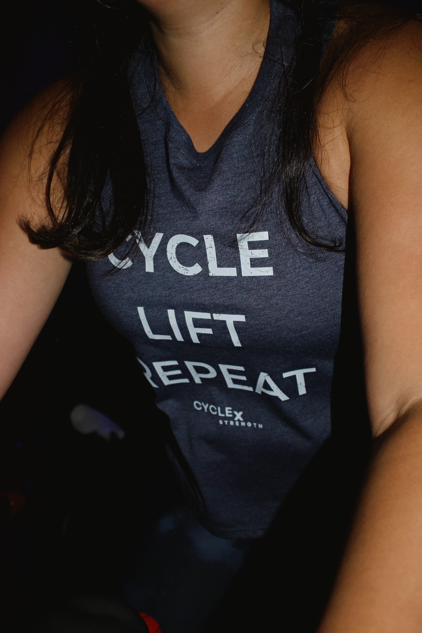 Close-up of a navy Cycle x Strength tank top printed with CYCLE LIFT REPEAT